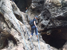Jinn rappelling down from the cave