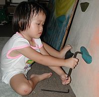 Robyn changing climbing holds