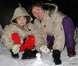 Robyn and Jin making a mini snowman