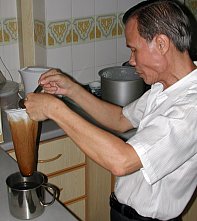 Grandpa brewing kopi in the traditional way