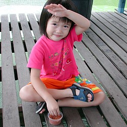 Robyn feeding fishes at Hausmann Fish Farm