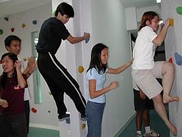 Volunteers having fun climbing on the wall