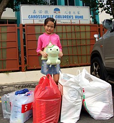 Robyn donates presents to the Canossaville Children's Home