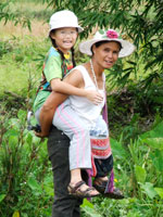 Mother Toma carrying Robyn over the paddies