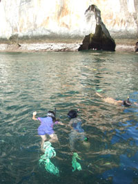 Robyn and Jin snorkeling towards the cave
