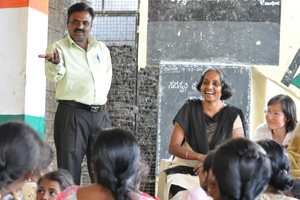 Yuvacharya and businessman Swamynathan urging the women to work together for self-reliance