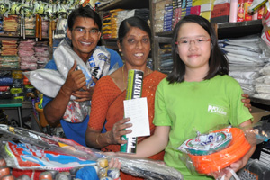 Yogendra and Robyn with the sports shop lday owner