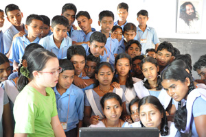Robyn coaching the tribal students on how to use PhotoShop and PowerPoint software.