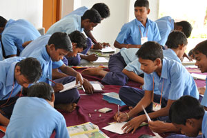 Hindoljuri Middle School - the students sat around in the assembly hall for their art creation.