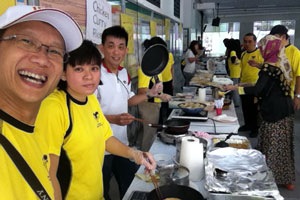 Parent volunteers cooking and serving our children